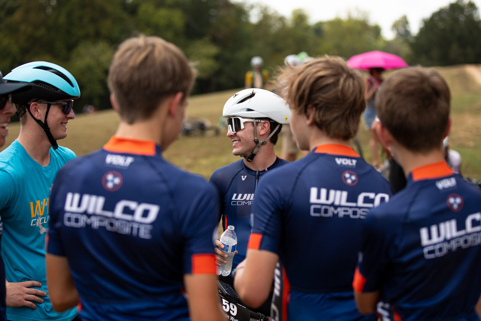Wilco riders in the navy-and-orange Volt race kit huddled before staging