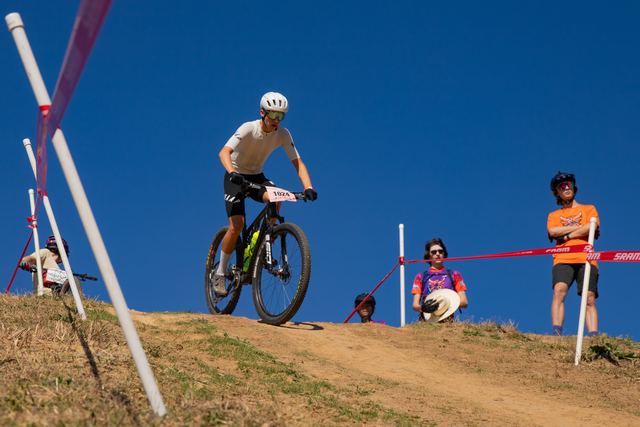 Riders cresting the whoops against a blue sky at Regionals